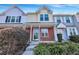 Brick front townhouse with a green door and landscaping at 7963 Shadow Oak Dr, North Charleston, SC 29406