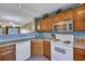 Corner kitchen with white appliances and wood cabinets at 7963 Shadow Oak Dr, North Charleston, SC 29406