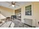 Covered screened porch with ceiling fan and sliding glass door at 7963 Shadow Oak Dr, North Charleston, SC 29406