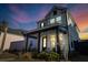 Two-story house with front porch and landscaped yard at sunset at 111 Crimson St, Summerville, SC 29486