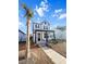 Two-story home with white siding, black accents, welcoming porch, and palm tree at 111 Crimson St, Summerville, SC 29486