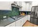 Modern kitchen features gas cooktop, stainless steel appliances, and green tile backsplash at 111 Crimson St, Summerville, SC 29486