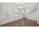 Bright dining room with hardwood floors, wainscoting, and a chandelier at 1216 Ashley Hall Rd, Charleston, SC 29407