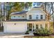 Two-story light blue house with white garage and landscaping at 1216 Ashley Hall Rd, Charleston, SC 29407