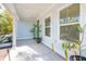 Front porch with light blue siding, potted plants, and white columns at 1216 Ashley Hall Rd, Charleston, SC 29407