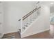 White staircase with wooden railing and hardwood floors at 1216 Ashley Hall Rd, Charleston, SC 29407