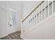 White staircase with wooden railing and hardwood floors at 1216 Ashley Hall Rd, Charleston, SC 29407