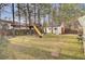 Large backyard with playset, including a treehouse and slide at 125 Trickle Dr, Summerville, SC 29483