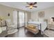 Spacious bedroom with a king-size bed, rocking chair, and hardwood floors at 125 Trickle Dr, Summerville, SC 29483