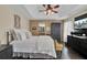 Main bedroom with a king-size bed, dark wood furniture, and a large TV at 125 Trickle Dr, Summerville, SC 29483