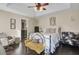 Bright bedroom with a queen bed, sitting area, and hardwood floors at 125 Trickle Dr, Summerville, SC 29483