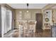 Bright dining room featuring a rustic wooden table and four chairs, hardwood floors, and access to backyard at 125 Trickle Dr, Summerville, SC 29483