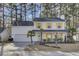 Two-story white house with yellow shutters, landscaping, and a driveway at 125 Trickle Dr, Summerville, SC 29483