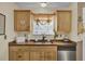 Kitchen features a butcher block countertop, stainless steel dishwasher, and a window with orange curtains at 125 Trickle Dr, Summerville, SC 29483