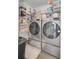 Laundry room with washer, dryer, and ample storage shelving at 125 Trickle Dr, Summerville, SC 29483