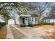 Quaint house with gray siding and a paved driveway at 1343 E Montague Ave, North Charleston, SC 29405