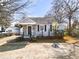 Gray house with a gray roof, small porch, and landscaping at 1343 E Montague Ave, North Charleston, SC 29405