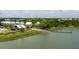 Aerial view showcases waterfront homes, a pier, boat launch, and kayak storage in community at 1474 Mizzen Aly, Johns Island, SC 29455