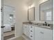 Double vanity bathroom featuring granite countertop and black hardware, bright and modern at 1474 Mizzen Aly, Johns Island, SC 29455