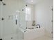 Modern bathroom with a glass-enclosed shower, soaking tub, and white subway tile at 1474 Mizzen Aly, Johns Island, SC 29455