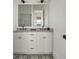 Double sink bathroom vanity with gray countertop, white cabinets, and decorative tile floor at 1474 Mizzen Aly, Johns Island, SC 29455