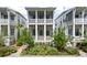 Charming white two-story home featuring a screened porch and landscaped front yard at 1474 Mizzen Aly, Johns Island, SC 29455