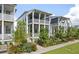 Charming home with double porches, white siding, and inviting landscaping in a walkable community at 1474 Mizzen Aly, Johns Island, SC 29455