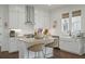 Modern kitchen with white cabinets, granite counters, and an island with bar seating at 1474 Mizzen Aly, Johns Island, SC 29455