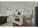 Open-concept kitchen and living area with hardwood floors and lots of natural light at 1474 Mizzen Aly, Johns Island, SC 29455