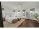 Spacious main bedroom with bright natural light, hardwood flooring and and ottomans at 1474 Mizzen Aly, Johns Island, SC 29455