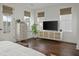 Bright main bedroom has hardwood floors, natural light and a console with mounted TV at 1474 Mizzen Aly, Johns Island, SC 29455