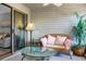 Relaxing sunroom with wicker furniture and glass top table at 1625 Live Oak Park, Seabrook Island, SC 29455