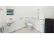 Small bathroom with toilet, sink, and grab bars at 1680 Banning St, Mount Pleasant, SC 29466