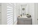 Small bathroom with a single vanity and a window with white plantation shutters at 1680 Banning St, Mount Pleasant, SC 29466