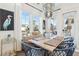 Charming dining area with light wood table and blue chairs near a window at 1680 Banning St, Mount Pleasant, SC 29466