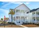 Two-story white house with a front porch and American flag at 1680 Banning St, Mount Pleasant, SC 29466