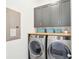 Convenient laundry room with washer, dryer, and upper cabinets at 1680 Banning St, Mount Pleasant, SC 29466