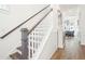 Modern staircase with dark wood treads and white risers at 1680 Banning St, Mount Pleasant, SC 29466
