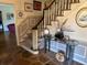 Inviting entryway with stone flooring, staircase, and decorative console table at 19 Fort Royal Ave, Charleston, SC 29407