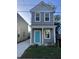 Two-story gray house with teal door, landscaping, and a paved driveway at 2023 Comstock Ave, North Charleston, SC 29405