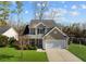 Two-story house with tan siding, a white garage door, and a well-manicured lawn at 2035 Culloden Dr, Summerville, SC 29483