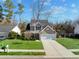 Tan house with a two-car garage, front porch, and a neatly kept lawn at 2035 Culloden Dr, Summerville, SC 29483