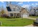 Two-story house with tan siding, a two-car garage, and a spacious yard at 2035 Culloden Dr, Summerville, SC 29483
