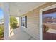 Covered porch with a glass front door, light fixtures, and shrubs at 2035 Culloden Dr, Summerville, SC 29483