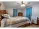 Comfortable bedroom with hardwood floors, ceiling fan, and decorative blue curtains at 206 Dukes St, Saint George, SC 29477
