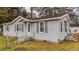 Charming single-story home with white siding, grey shutters, and a cozy front porch at 206 Dukes St, Saint George, SC 29477