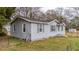 Side view of a single-story home with white siding, grey shutters, and well-maintained lawn at 206 Dukes St, Saint George, SC 29477