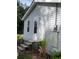 House side view, showing a white door and gray vinyl siding at 206 Dukes St, Saint George, SC 29477