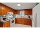 Cozy kitchen featuring wooden cabinets, white appliances, and neutral countertops at 206 Dukes St, Saint George, SC 29477
