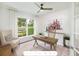 Home office with wood desk, comfortable chair, and large windows at 2082 Cousteau Ct, Johns Island, SC 29455